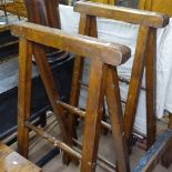 A pair of Antique stained beech folding trestles, W68cm, H133cm
