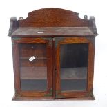 An oak hangin smoker's cabinet, glazed door with raised gallery and fitted interior, height 36cm