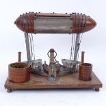 An unusual hot air balloon/zeppelin design desk stand, with inkwell, match holder, cigar cutter