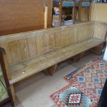A Victorian polished pine church pew, with panelled back, L229cm, H83cm, D42cm, seat height 43cm,