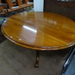 A Victorian mahogany oval loo table, raised on turned centre column and tripod base, W138cm