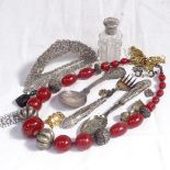 A tray of items containing a jet pin cushion, Swedish silver brooch, silver-top scent bottle,