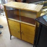 A mid-century part glazed bubinga or teak cabinet on ebonised boomerang legs, by Butilux, with