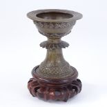 An Oriental bronze pedestal incense burner, on turned wood stand, overall height 18cm