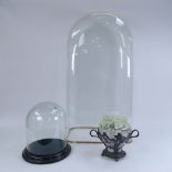 A large dome-top glass dome, another glass dome and base, and an Art Nouveau WMF silver plate and