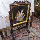 A William IV rosewood fire screen, the glazed panel set with floral display, on pierced stand,