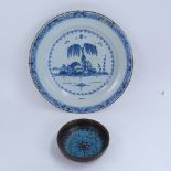 A Chinese blue and white tin glaze plate, and a cloisonne enamel ginger jar lid, plate diameter 24cm