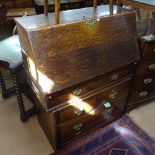 An Antique oak bureau with a fall-front and graduated drawers under, W91cm, D50cm, H112cm