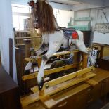 A painted rocking horse on pine stand, H125cm