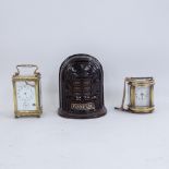 A Vintage Fobrux glazed cast-iron money bank, a Forum oval brass-cased carriage clock, and another