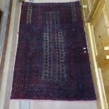 An Antique red ground Balochi prayer rug, 138cm x 90cm