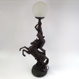 A large resin figural table lamp, depicting nude figure standing on horseback, with crackle shade,