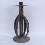 A large Arts and Crafts silver plate on copper table candlestick, hand planished decoration with