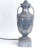 A Victorian style aluminium pedestal urn table lamp, relief embossed Classical figure and Adam style