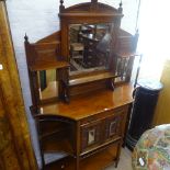 A late Victorian walnut mirror-back chiffoniere, with fitted drawer cupboards and open shelves,