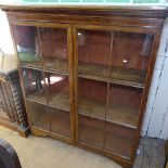 A George III mahogany bookcase, with 2 lattice-glazed doors on bracket feet, W136cm, D40cm, H154cm