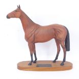 A Beswick Connoisseur figure of Red Rum on wooden plinth