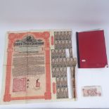An Imperial Chinese Government £100 bond, British shilling banknotes, and a Bond catalogue