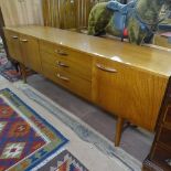 A mid-century teak sideboard fitted with drawers and cupboards, L203cm, D43cm, H70cm