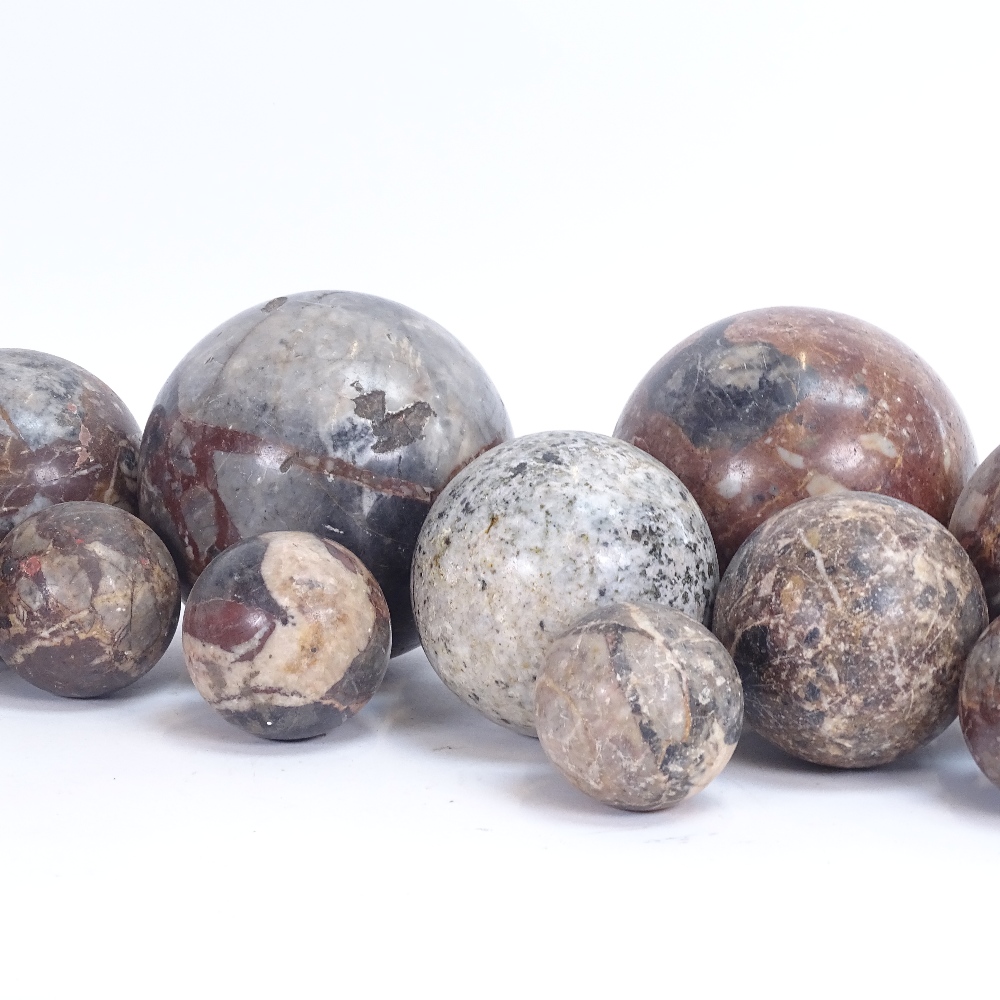 Various carved and polished hardstone orbs, including jasper, largest diameter 13cm