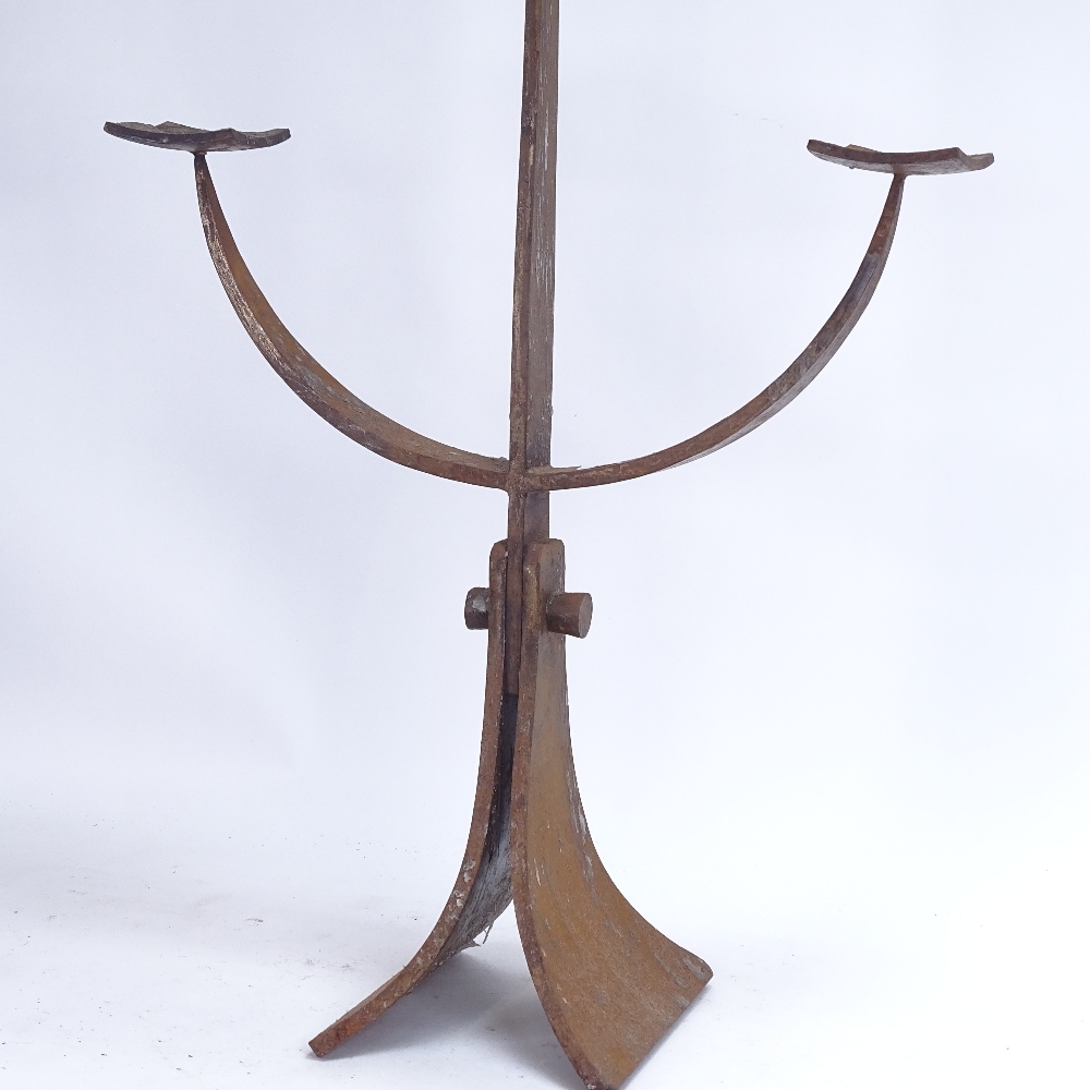 A large cast-iron candle holder, height 84cm