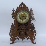 A painted cast-iron 8-day mantel clock, enamel dial with pendulum and key, height 36cm