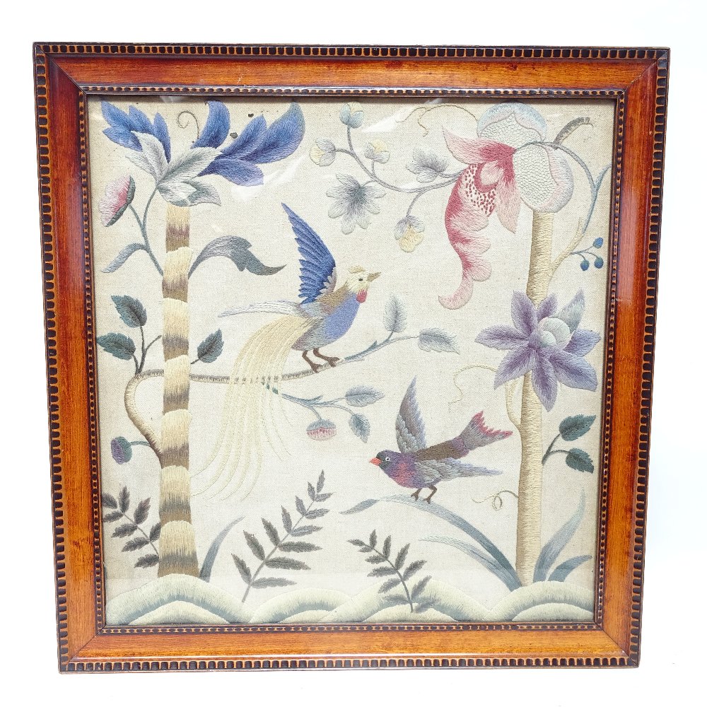 An Oriental woolwork embroidery, depicting birds of paradise and nature, framed, frame height 65cm