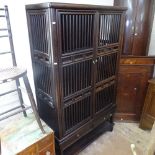 An Oriental design hardwood 2-section cabinet, with turned spindle panels and 2 doors, with