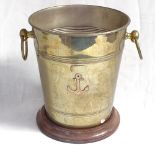 A silver plated 2-handled ice bucket, on turned wood stand with brass anchor motif, overall height