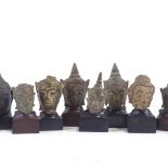 10 miniature cast bronze Thai Buddha heads, with later made hardwood stands, tallest 6cm with stand.