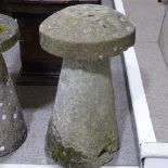 A weathered stone saddle stone, height 74cm, diameter 41cm Chip on one side of the base and