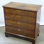 An 18th Century crossbanded walnut chest of 4 long drawers, width 47cm, height 89cm.