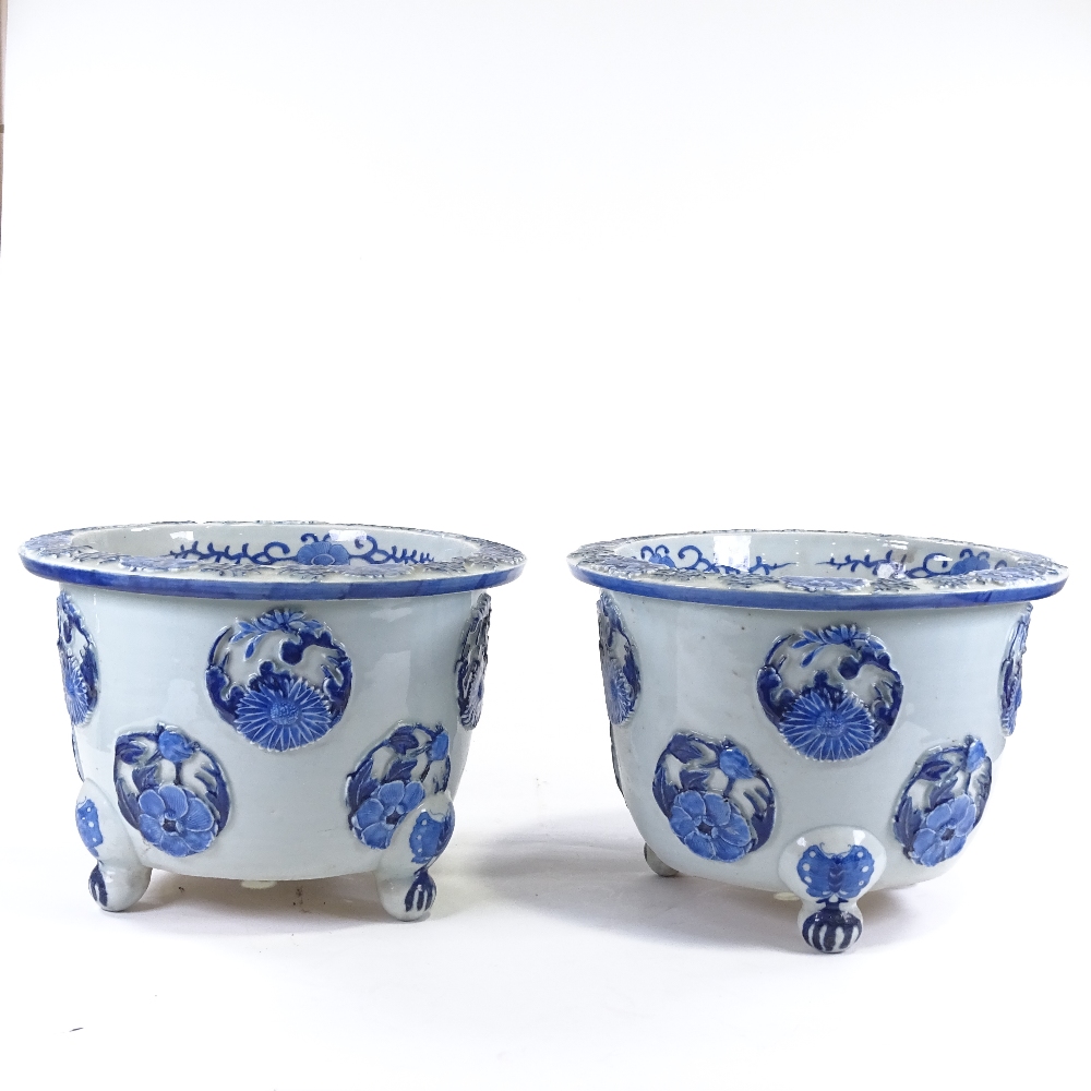 A pair of Japanese Meiji period blue and white porcelain jardinieres, with relief flower panels - Image 2 of 13