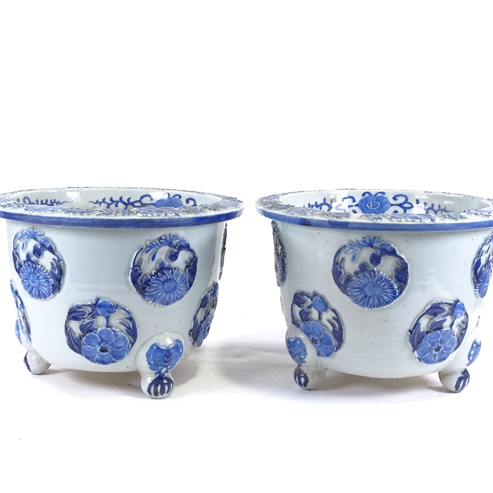 A pair of Japanese Meiji period blue and white porcelain jardinieres, with relief flower panels - Image 13 of 13