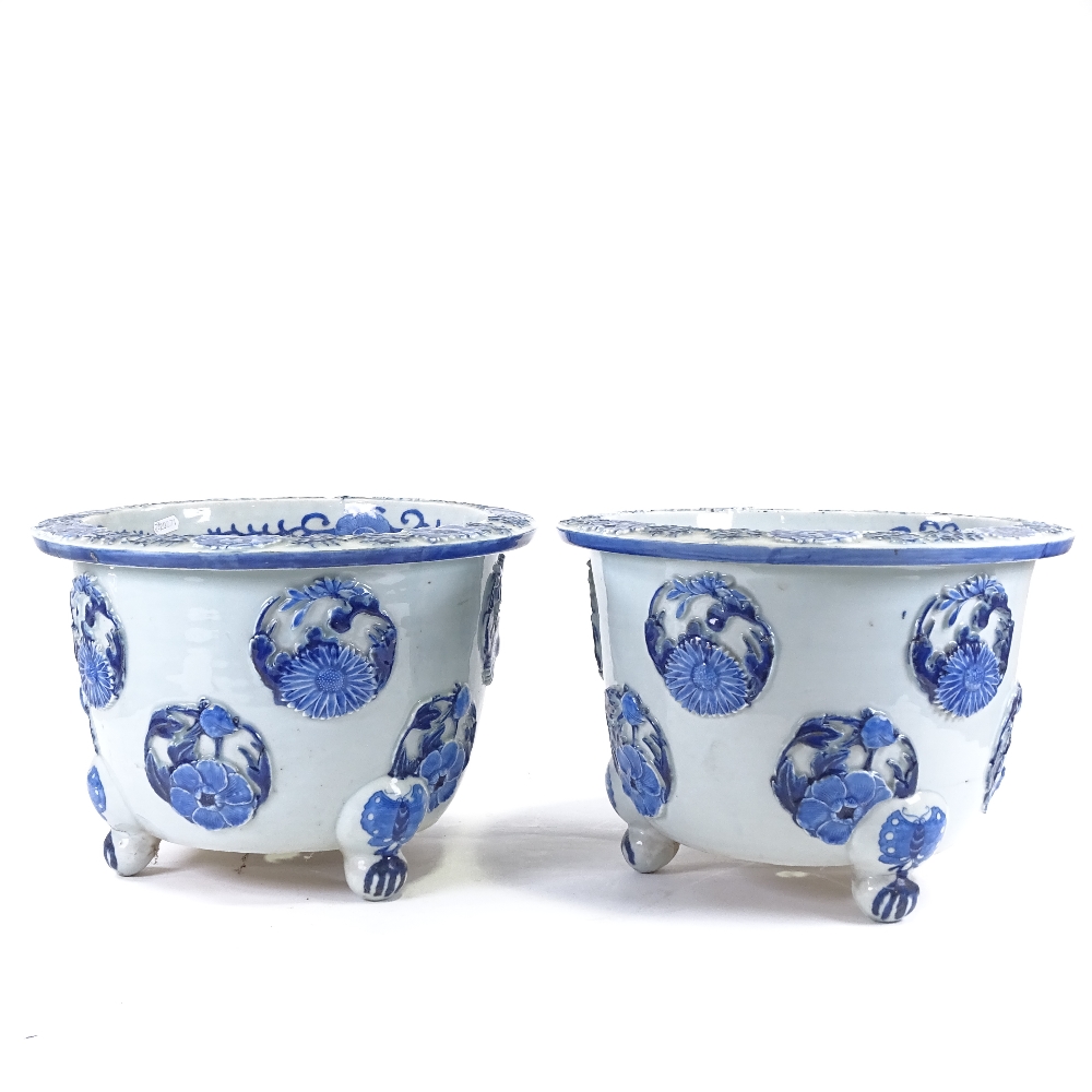 A pair of Japanese Meiji period blue and white porcelain jardinieres, with relief flower panels - Image 6 of 13