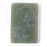 A Chinese relief carved jade rectangular pendant plaque, length 7cm