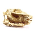A 19th century ivory netsuke, in the form of a dragon in a shell, signed to base, length 5cm. In