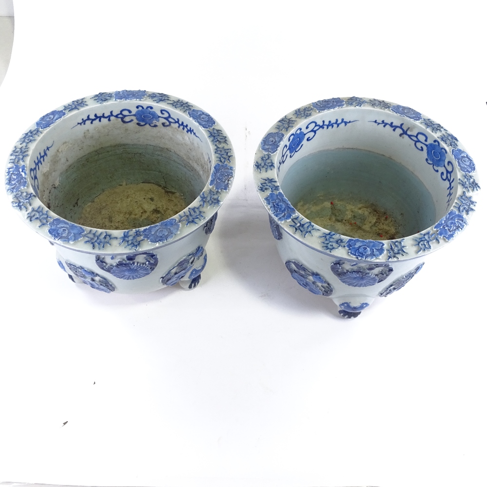 A pair of Japanese Meiji period blue and white porcelain jardinieres, with relief flower panels - Image 3 of 13