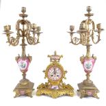 A continental ormolu clock and pair of candelabra, with enamelled dial and pink painted porcelain