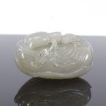 A Chinese celadon jade carving, probably 18th or 19th century, in the form of a Swan and Cygnet on a