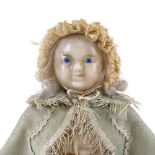 A Victorian wax head and limb doll, with painted blue eyes and features and inserted hair, in