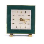 LOOPING - a Swiss Art Deco 8-Day brass and green enamel travelling alarm clock, silvered dial with