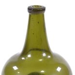 An 18th century handmade green glass onion-shaped bottle, height 17cm