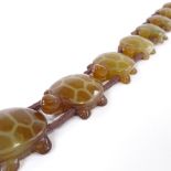 A Chinese carved hardstone tortoise design necklace