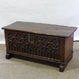 An Antique oak coffer with relief carved Gothic tracery panelled front, length 114cm