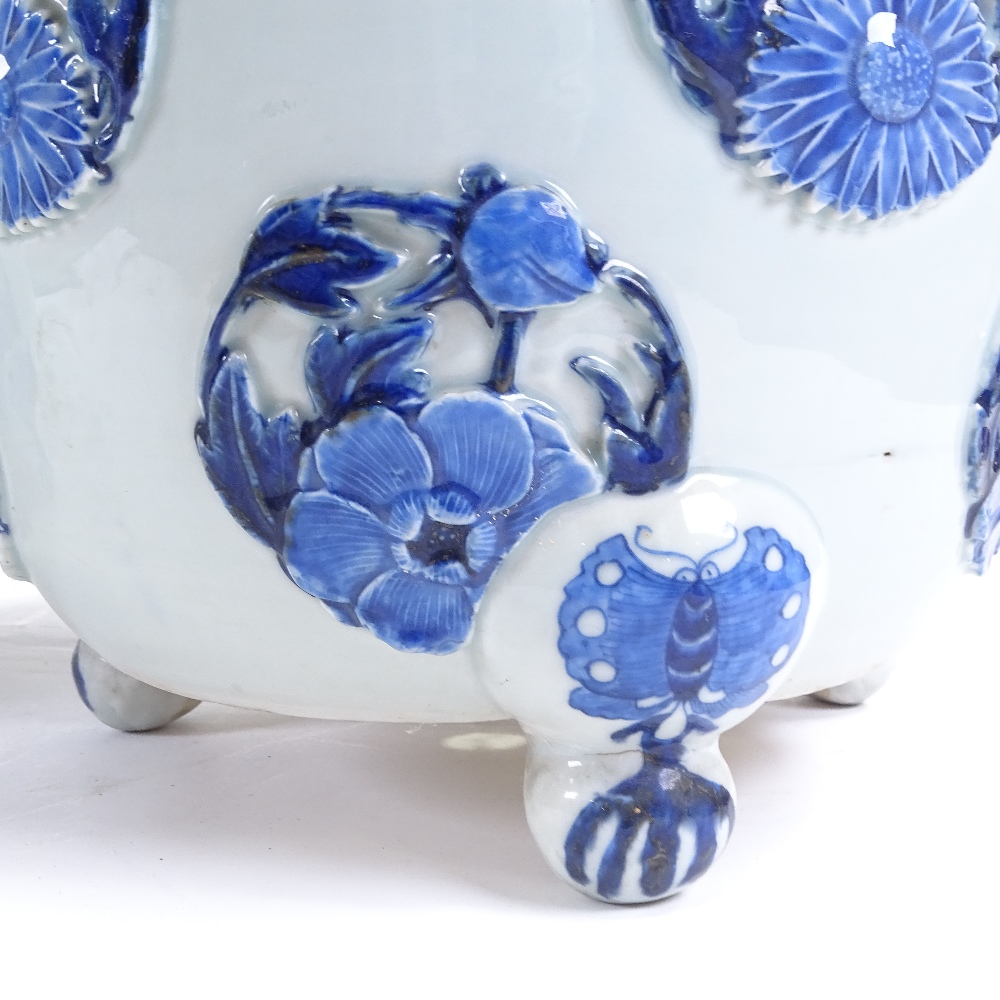 A pair of Japanese Meiji period blue and white porcelain jardinieres, with relief flower panels - Image 7 of 13