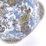 A Japanese underglaze blue and white dish, with relief colour enamel and 8 character marks to