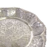 A large Indian white metal circular tray, floral swag and eternal knot decoration with scalloped
