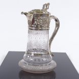 A Victorian silver mounted etched glass claret jug, with Bacchanalian detail and lion thumb plate,