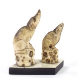 A pair of carved stag horn netsuke rats, on common hardwood and ivory base, height 7cm. Both